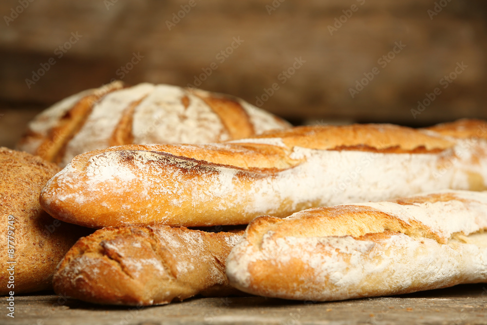 Different fresh bread on old wooden table