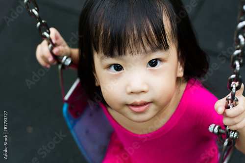 Asian Kid Swing At Park