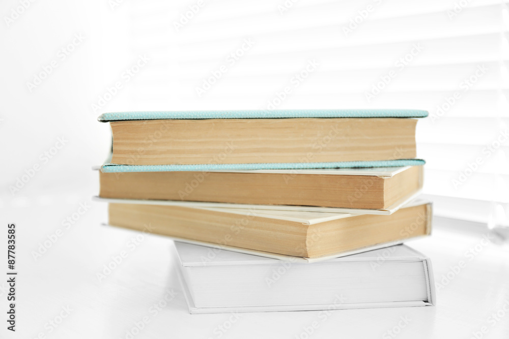 Books on white windowsill, close up Books on white windowsill, close up