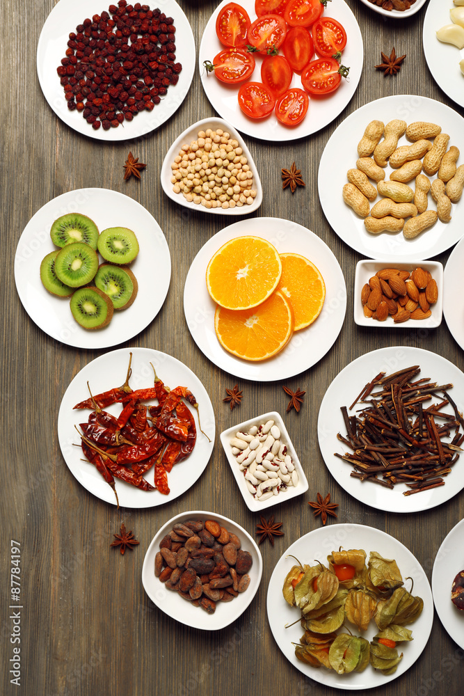 Different products on saucers on wooden table, top view Different products on saucers on wooden table, top view