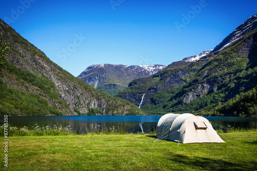 Tourist tent on the shore of the lake. © Andrei Armiagov