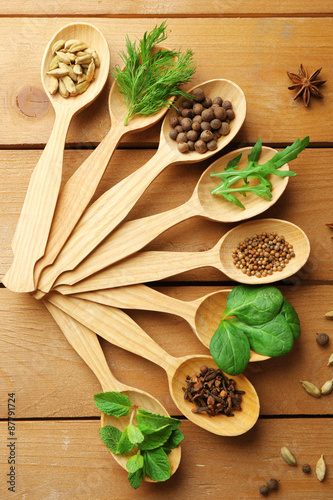 Fototapeta Naklejka Na Ścianę i Meble -  Wooden spoons with fresh herbs and spices on wooden background