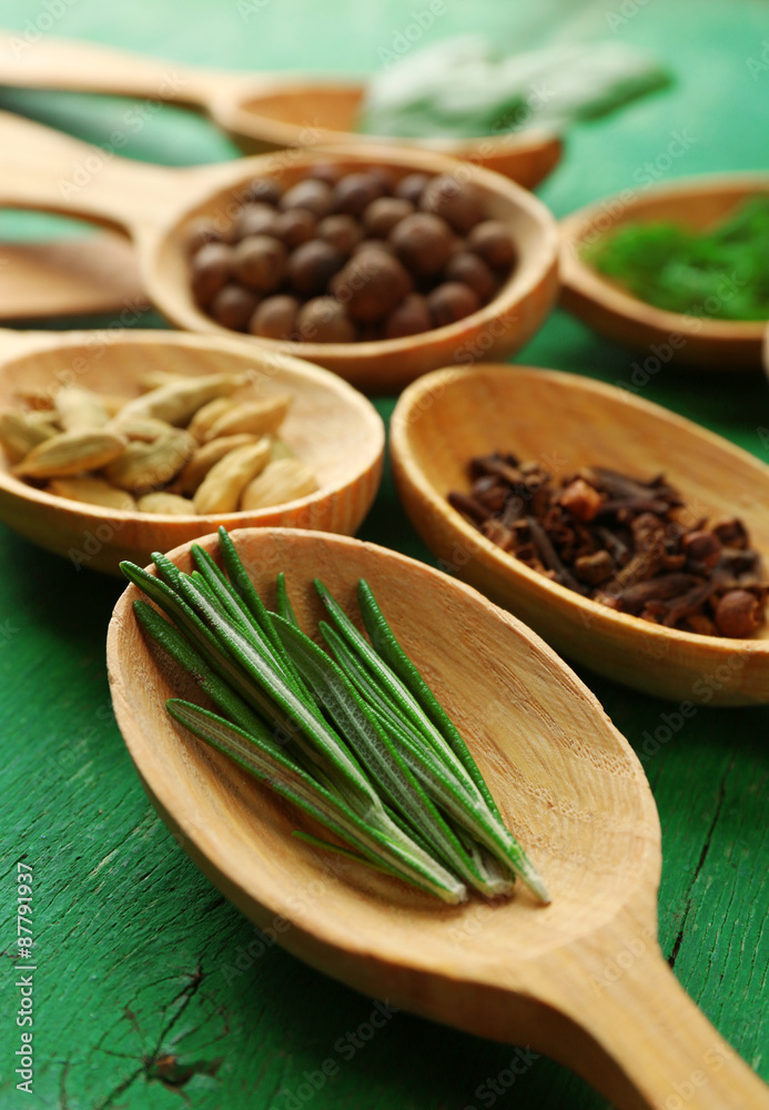 Wooden spoons with fresh herbs and spices on wooden background Wooden spoons with fresh herbs and spices on wooden background
