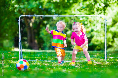Kids playing football in school yard © famveldman