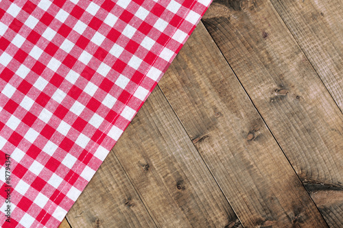 Checkered napkin on wooden table background