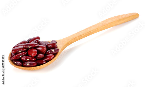 Red kidney beans on a wooden spoon isolate on white