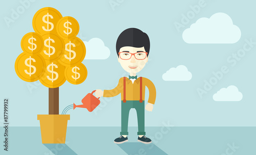 Asian businessman happily watering the money tree.