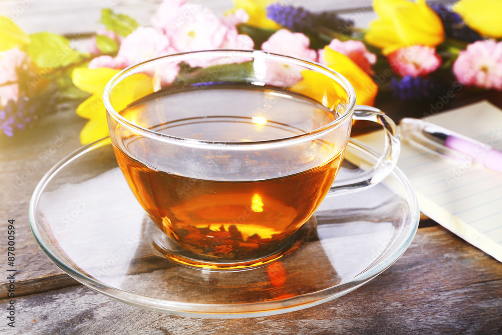 Cup of herbal tea with flowers on wooden table, closeup Cup of herbal tea with flowers on wooden table, closeup