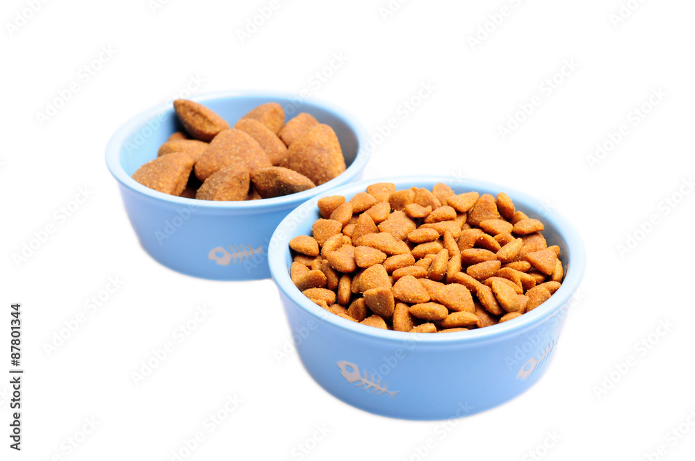 Blue ceramic dogs bowl. Dry dog food in bowl isolated on white background. Blue ceramic dogs bowl. Dry dog food in bowl isolated on white background.