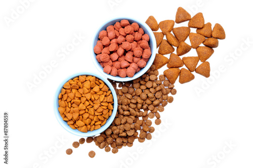 Blue ceramic dogs bowl. Dry dog food in bowl isolated on white background.