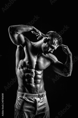 very muscular handsome athletic man on black background
