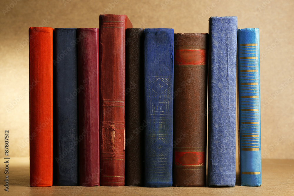 Old books on shelf, close-up, on wooden background Old books on shelf, close-up, on wooden background