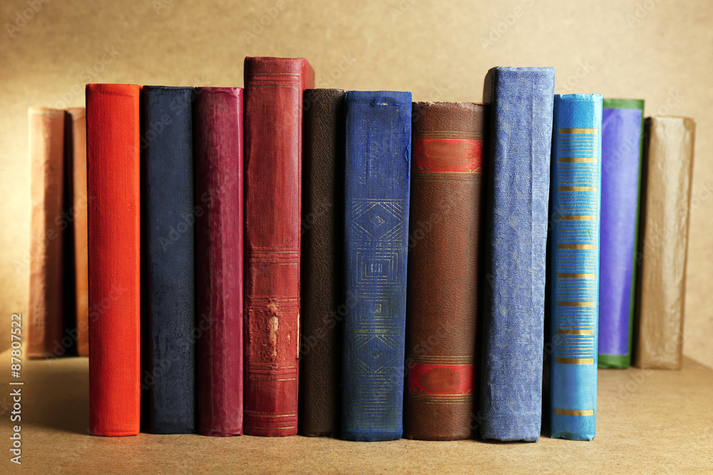 Old books on shelf, close-up, on wooden background Old books on shelf, close-up, on wooden background