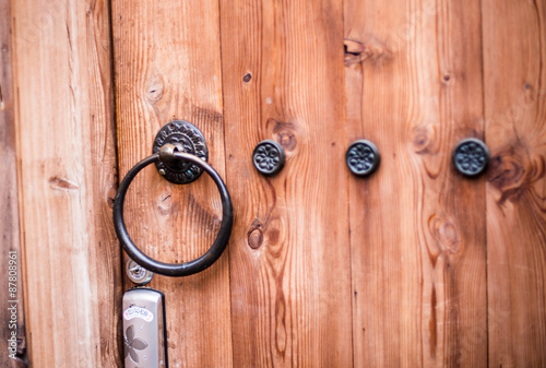 metal door knocker on wood door
