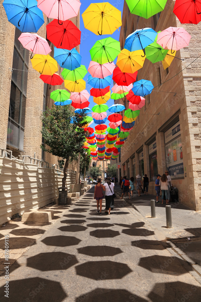 JERUSALEM,ISRAEL - JULY 19,2015:Colorful umbrellas floating magically in  the sunny blue sky above pedestrian Yoel Moshe Salomon Street with  galleries, ceramics, arts jewelry and clothing shops Stock Photo | Adobe  Stock