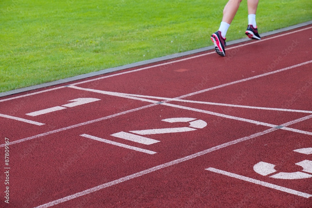 Red running racetrack on the stadium with two running legs