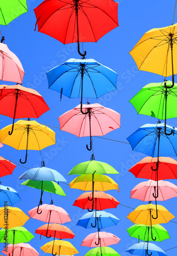 Colors / Colorful umbrellas floating magically in the sunny blue sky