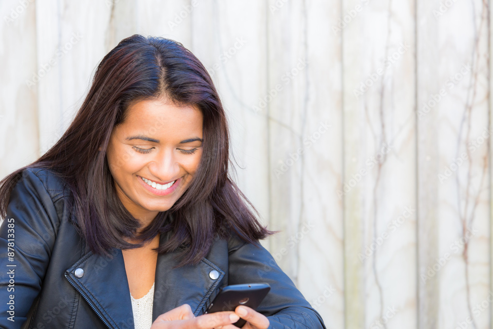Beautiful Indian woman using her cell phone Beautiful Indian woman using her cell phone