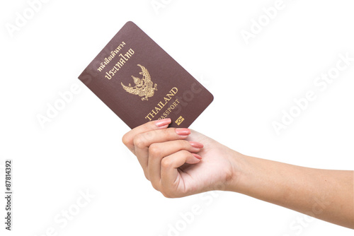 Hand holding passport isolated.