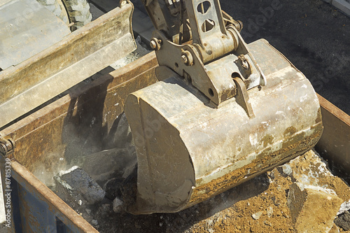 bulldozer excavator machine industry picks up debris on city str