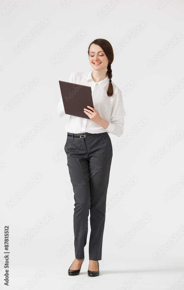 Smiling young businesswoman holding clipboard Smiling young businesswoman holding clipboard