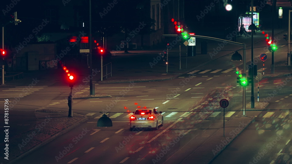 City street crossroad night traffic scene with cars, buses and pedestrians, time lapse footage.