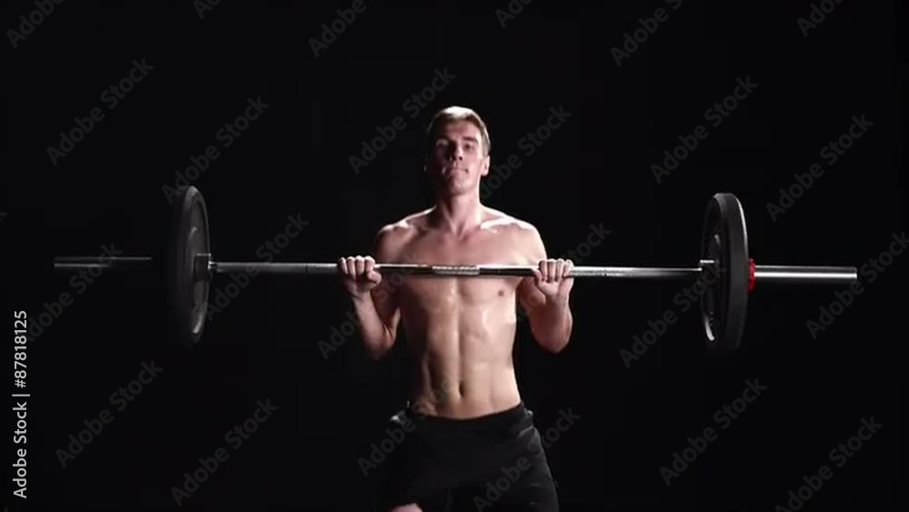 Shirtless man performing a power clean Shirtless man performing a power clean