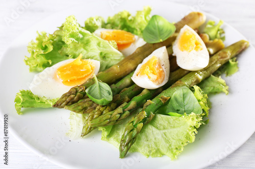 Plate of dietary salad with boiled asparagus and egg, closeup