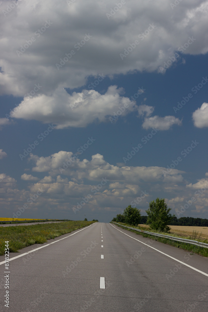 Fototapeta premium Asphalt road over blue sky background. 
