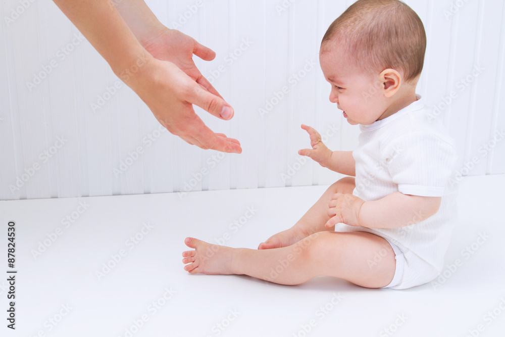 Beautiful baby with mother hands help on white background Beautiful baby with mother hands help on white background
