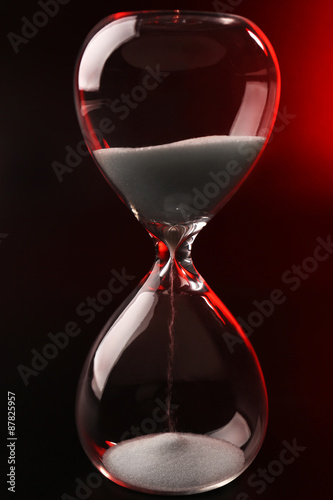 Hourglass on dark red background