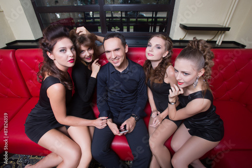 sexy lovelace man surrounded by hot women wanting of proposal photo