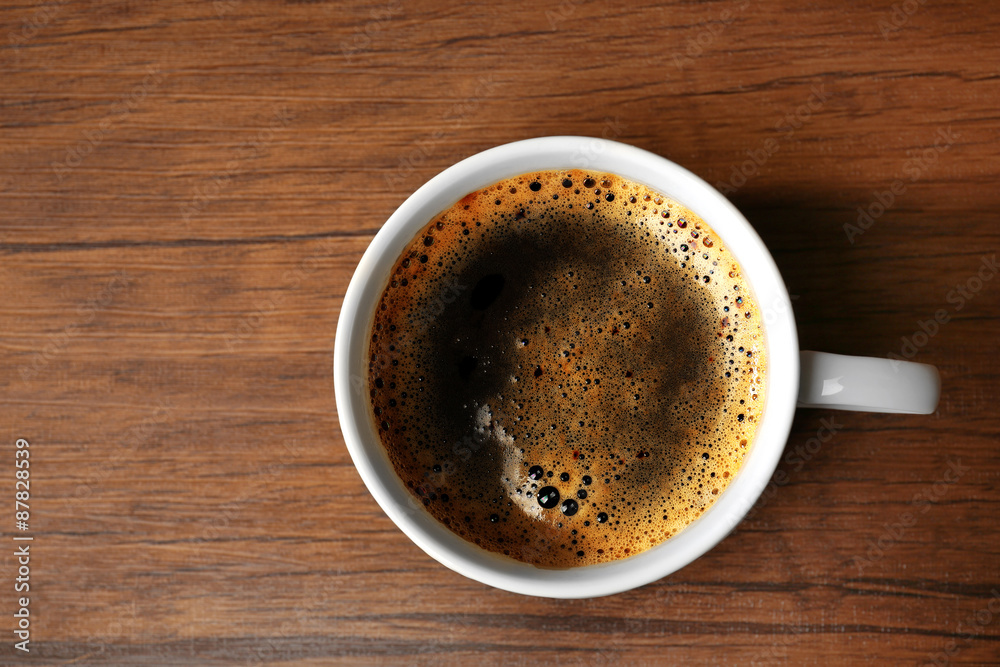 Cup of fresh coffee on wooden table, top view Cup of fresh coffee on wooden table, top view