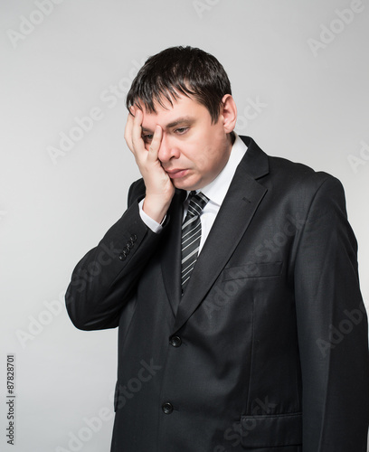 portrait of a young businessman hand covers the face