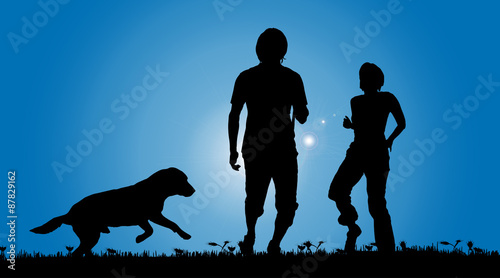Vector silhouette of a couple with a dog.
