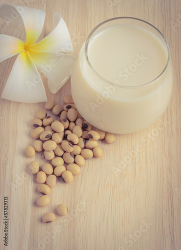 Fresh Soy milk (Soya milk) in a glass and soybean seeds in vintage filter color style