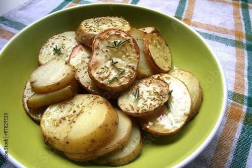 Baked potato on the plate with spices