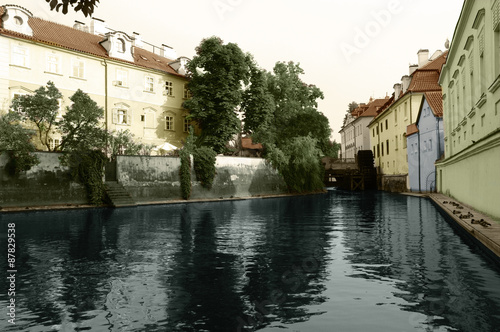 view from the Charles Bridge in the narrow channel in Prague