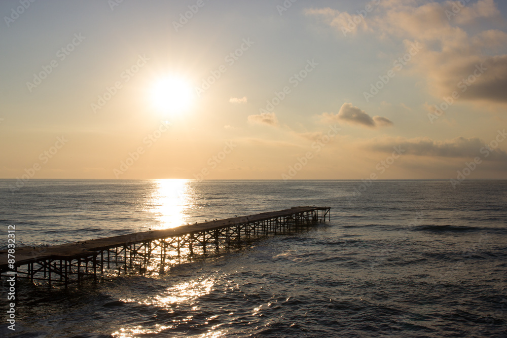 Sunrise over sea pier