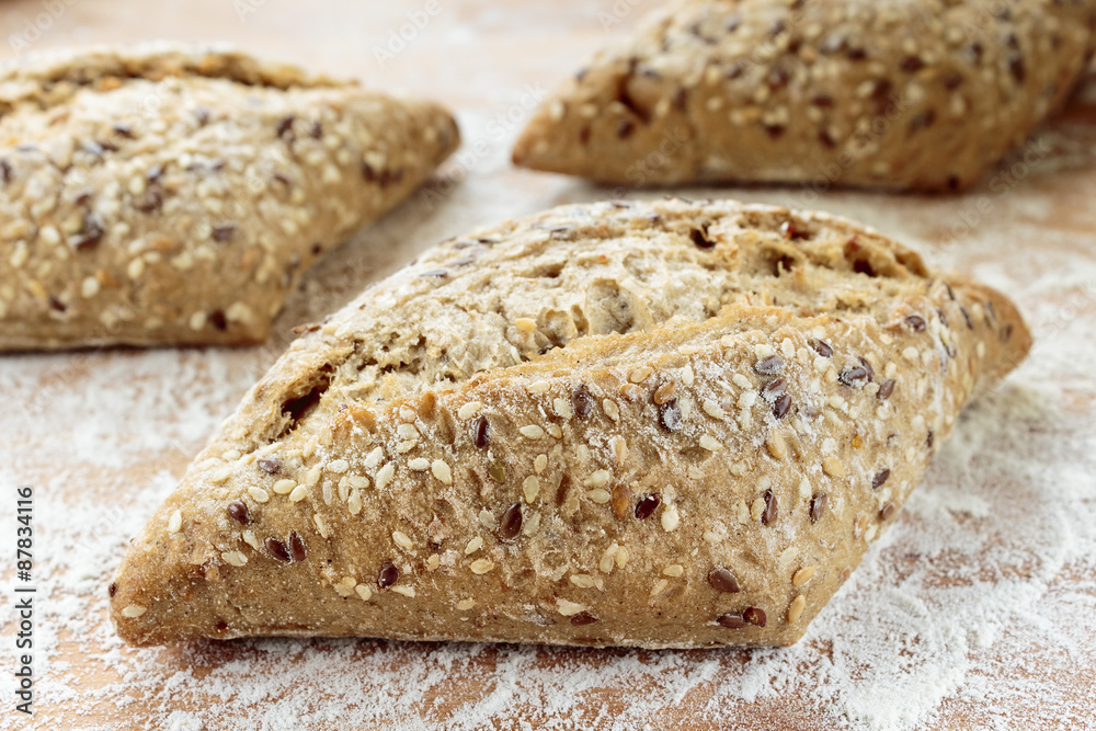 Small Tuscany baguette on a wooden board sprinkled with flour