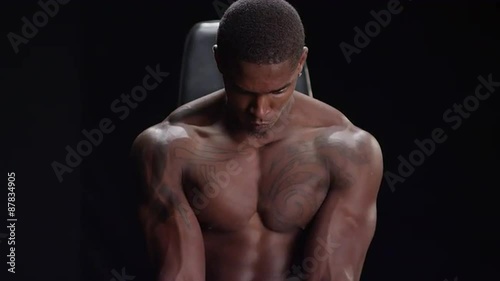 Muscular black man resting between workouts photo
