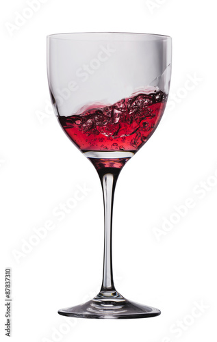 wine is poured into a glass on a white background
