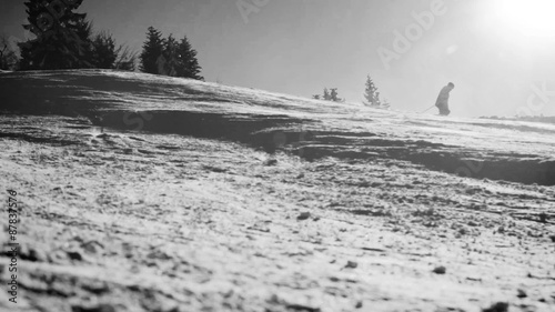 Black and white footage of skiers going down the slope