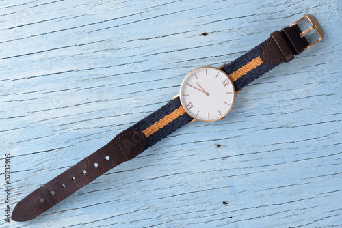 Wristwatch on old wooden table