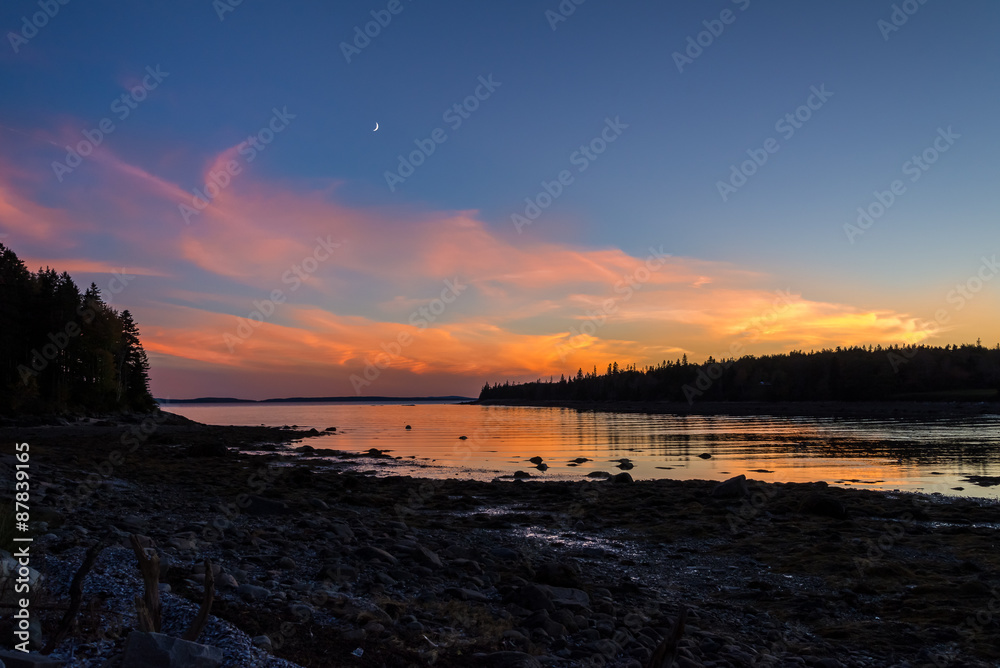 Moon Sunset.  Sunset over Atlantic ocean, Maine, USA, with moon rising