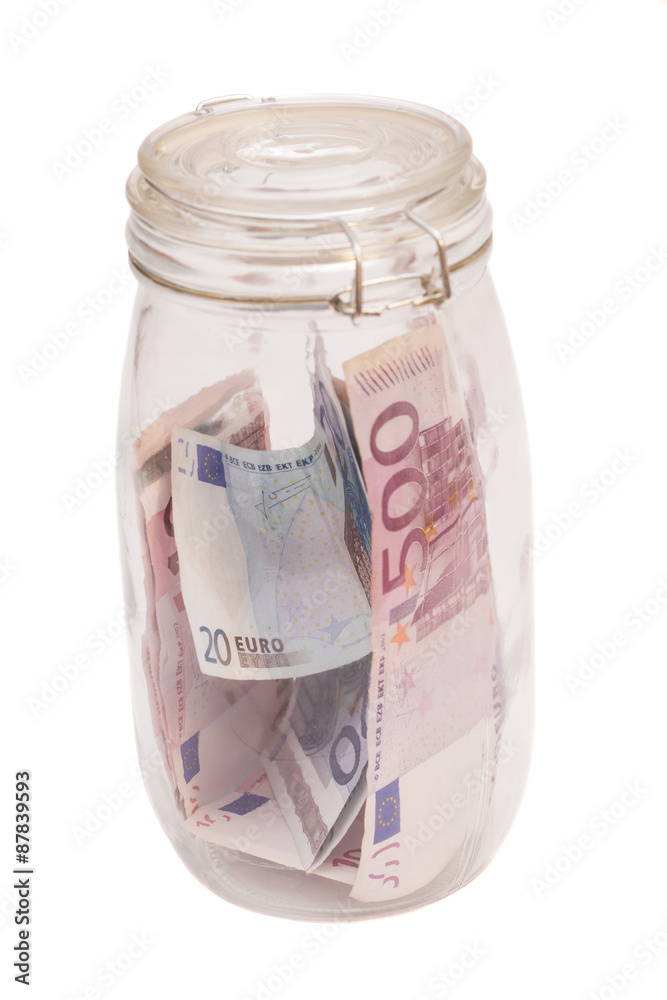 Money jar containing Euro notes isolated on white Money jar containing Euro notes isolated on white