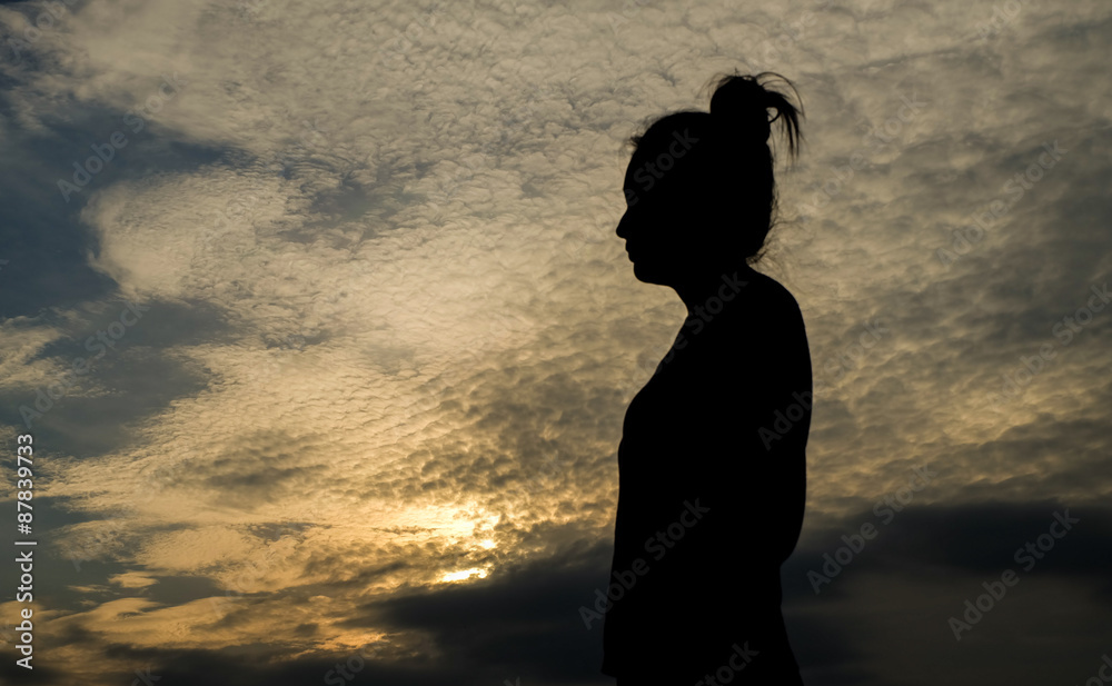 Art tone of woman silhouette with beautiful sunset sky background