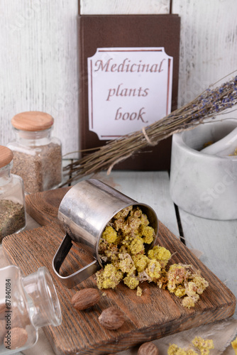 Dried herbs with nutmeg on table close up