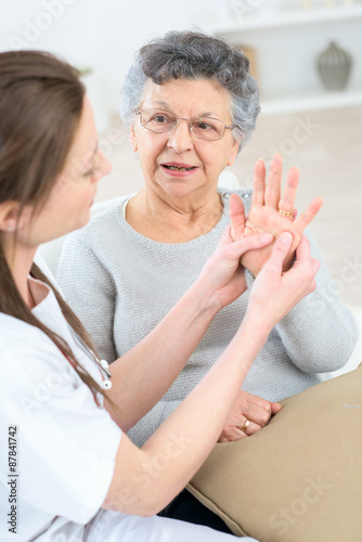 Checking an old lady's hands