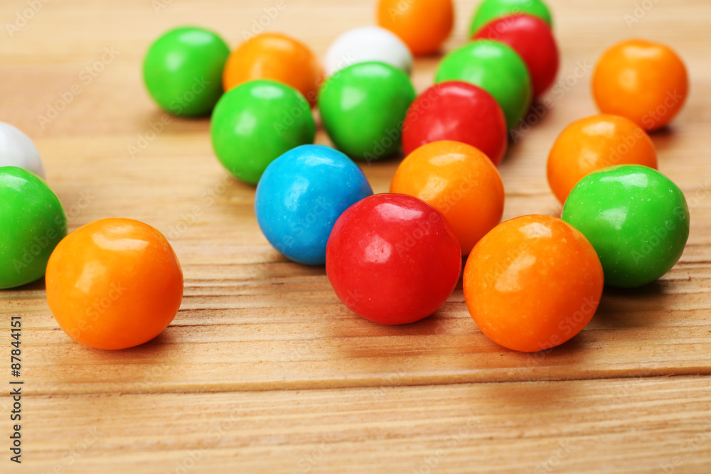 Colorful candies on wooden table, closeup Colorful candies on wooden table, closeup